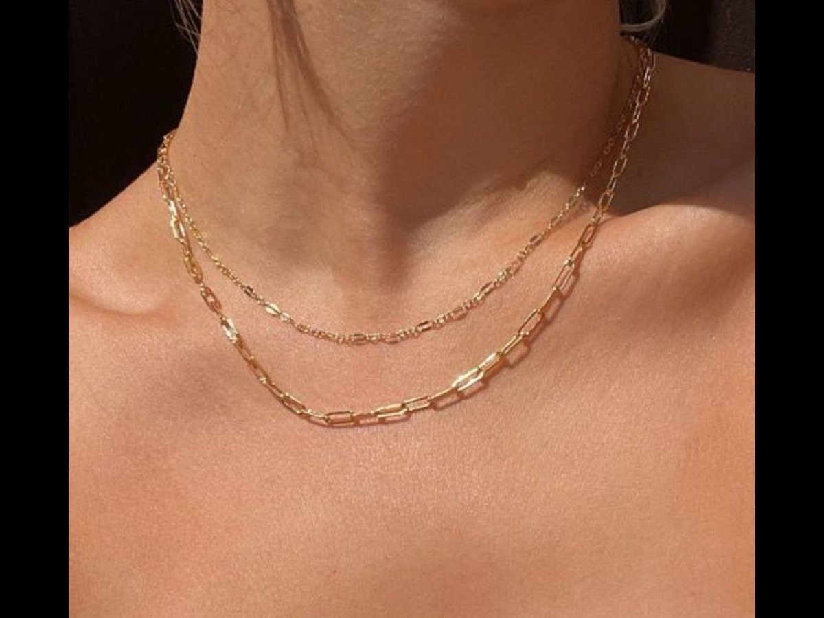 Layered gold permanent jewelry necklace close-up